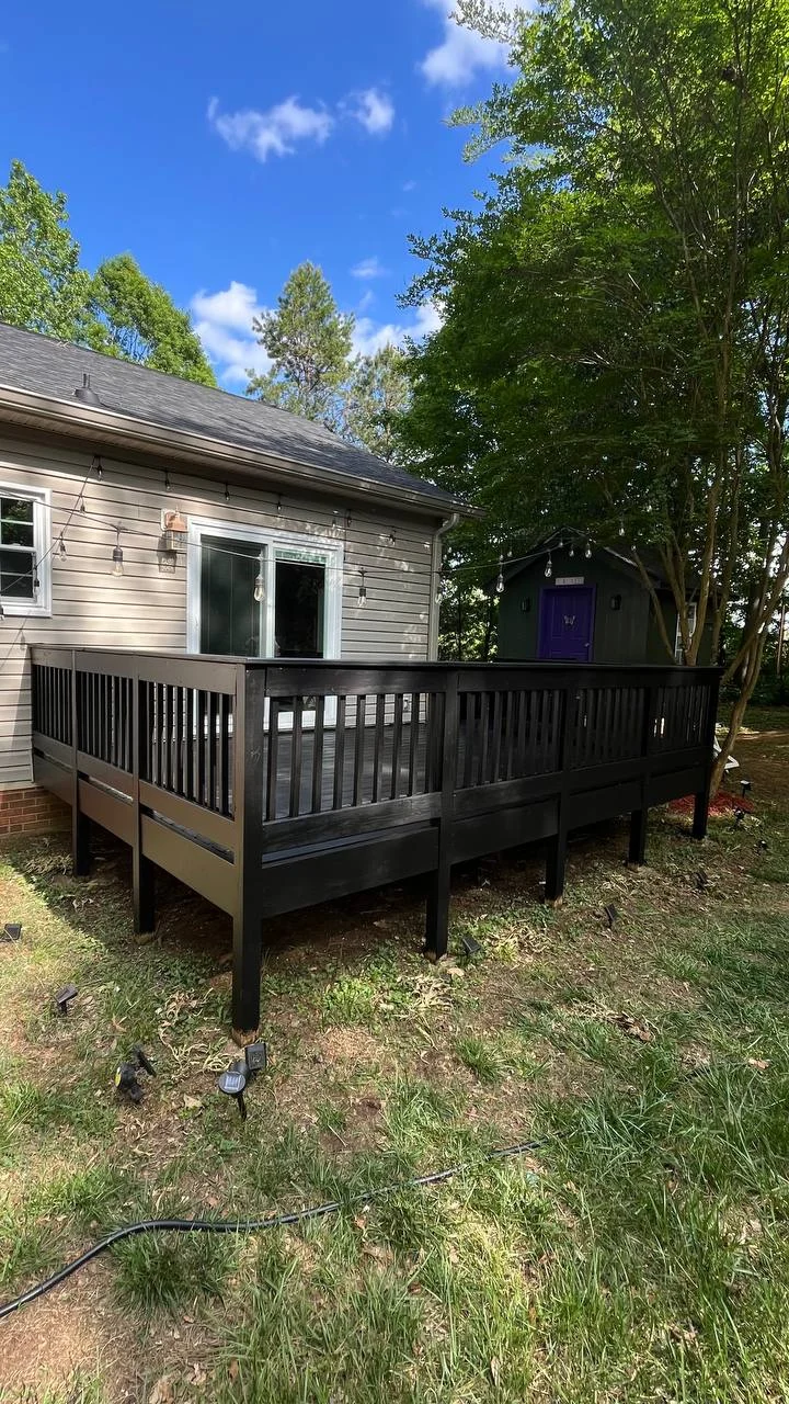 A backyard deck sits among mature trees with dark perimeter railings and space along the home. Finished views are paired with crew and installation photographs from the work area.