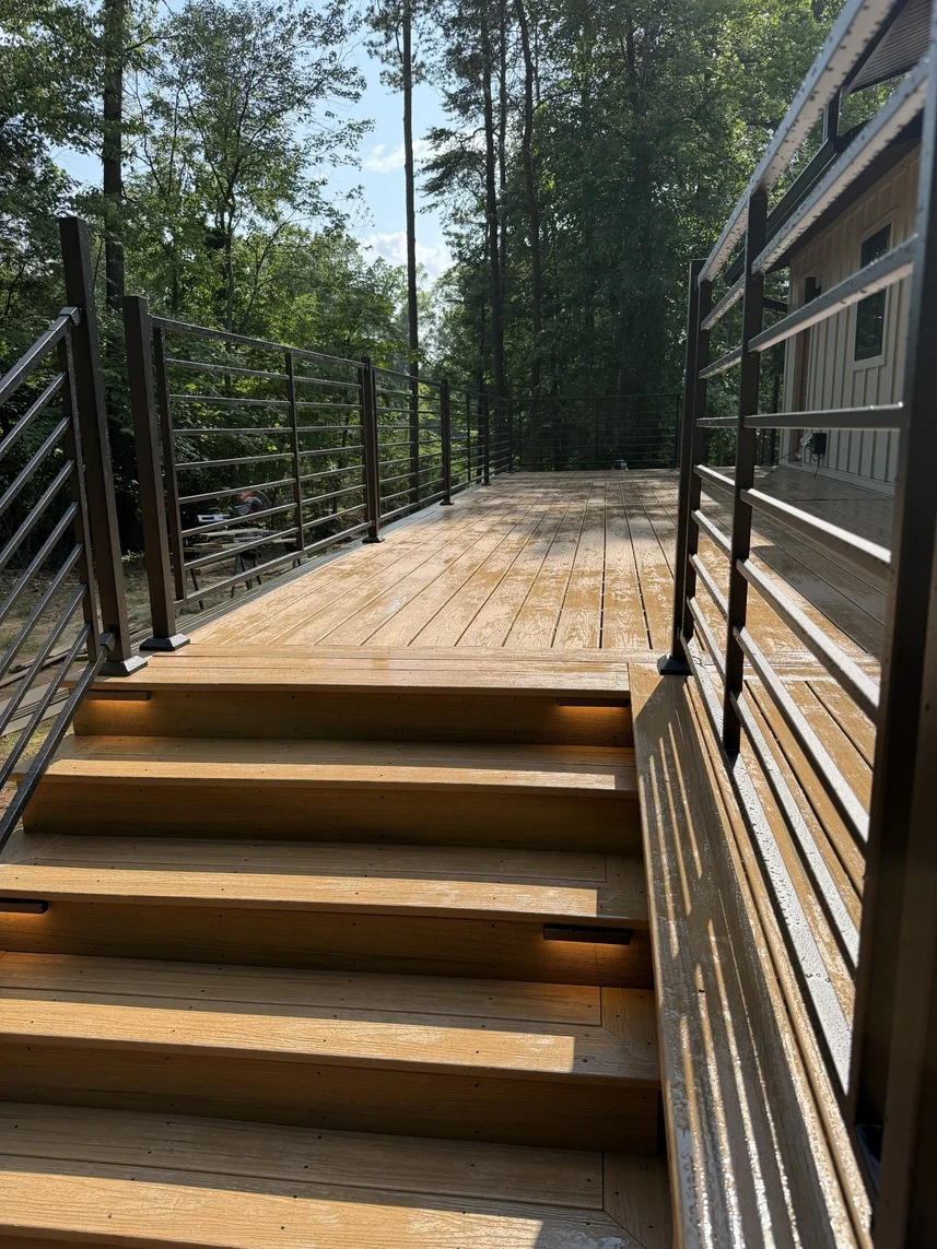 Composite deck stairs with picture-frame detailing and contrasting railing