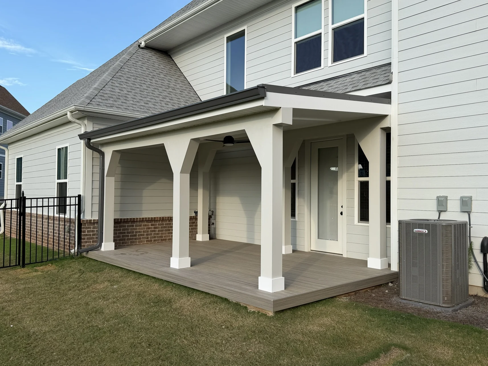 Buddy Buildings attached covered outdoor space with white architectural trim and Trex composite decking
