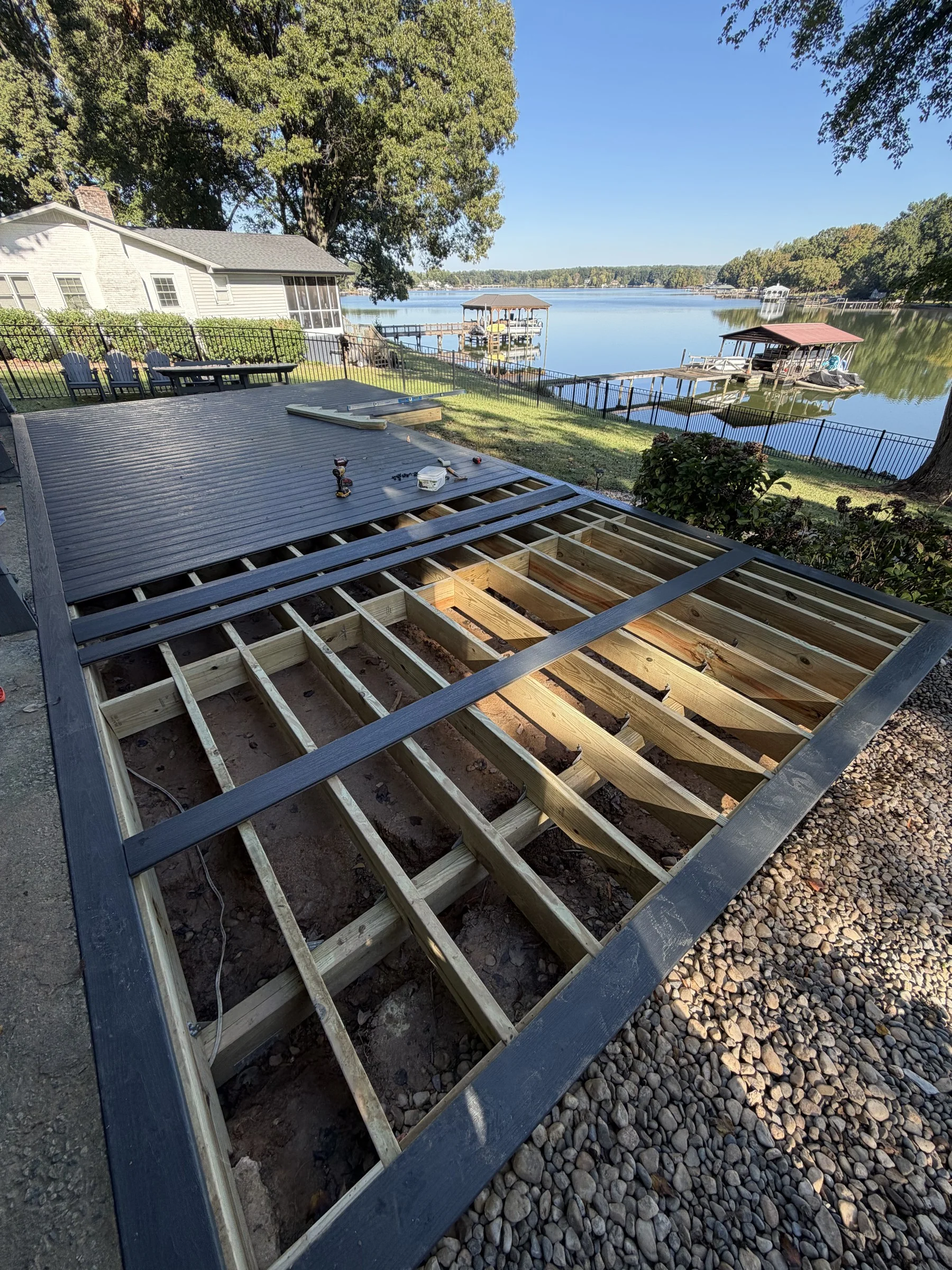 Construction progress: decking installation over the custom structural frame.