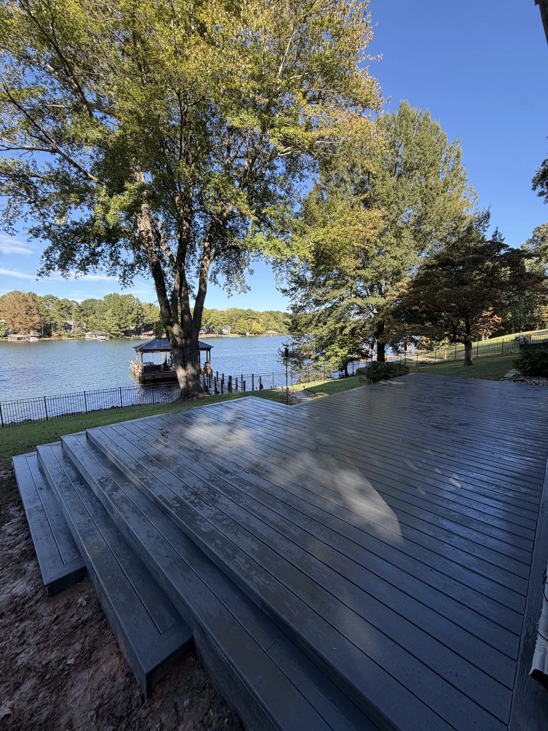 Wraparound stairs follow the sloped yard while keeping the lake views open.