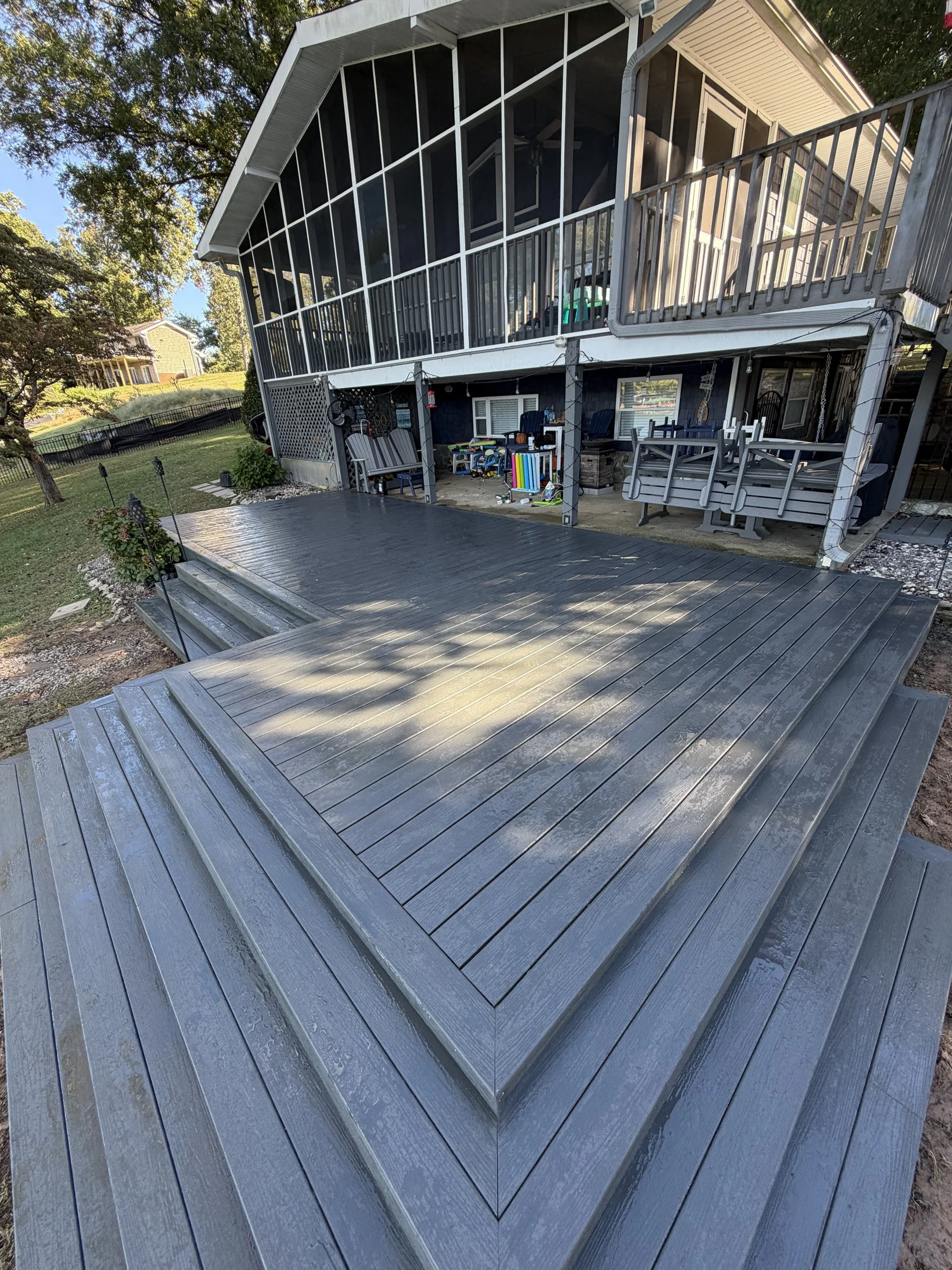 Picture-frame borders and precise corner transitions on the finished deck and stairs.